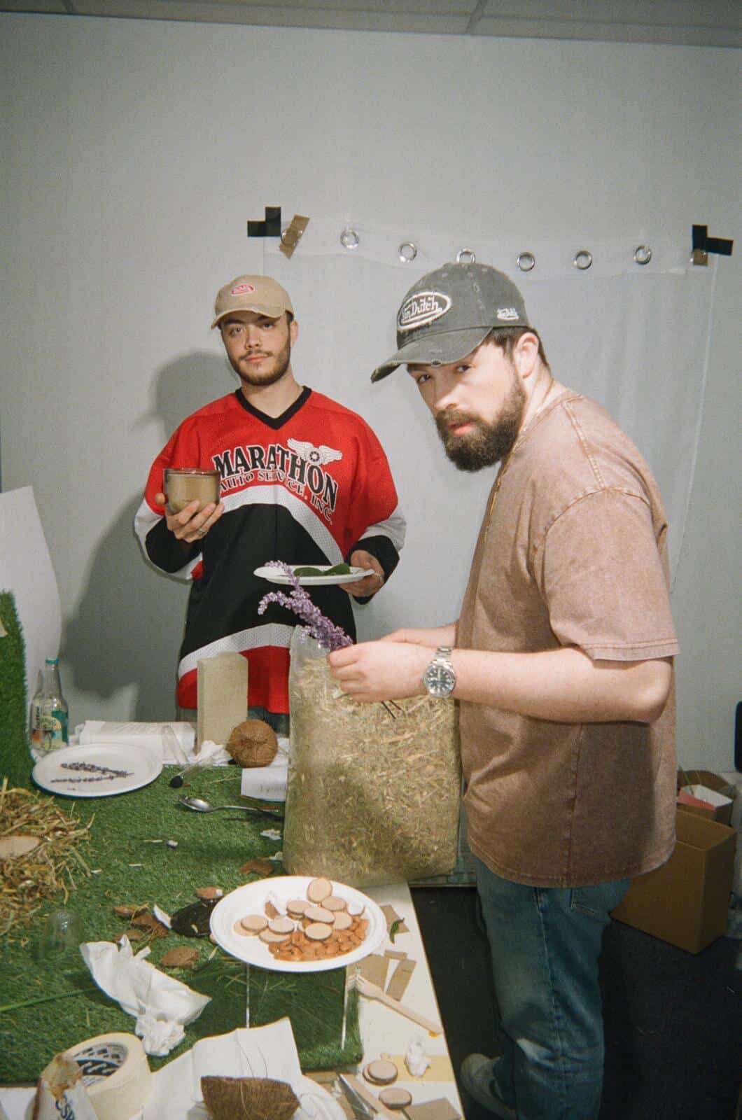 Josh and Valerio arranging products and botanical props for a photo shoot